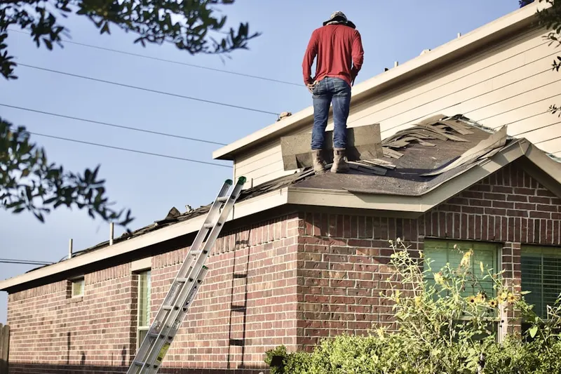 Professional roofer working on a residential roof in Rockspring